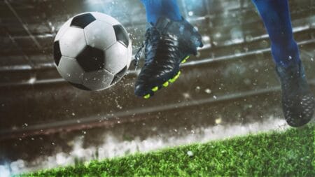 Données du LOSC entre les matchs et paris sur le football Joueur frappant le ballon dans le stade